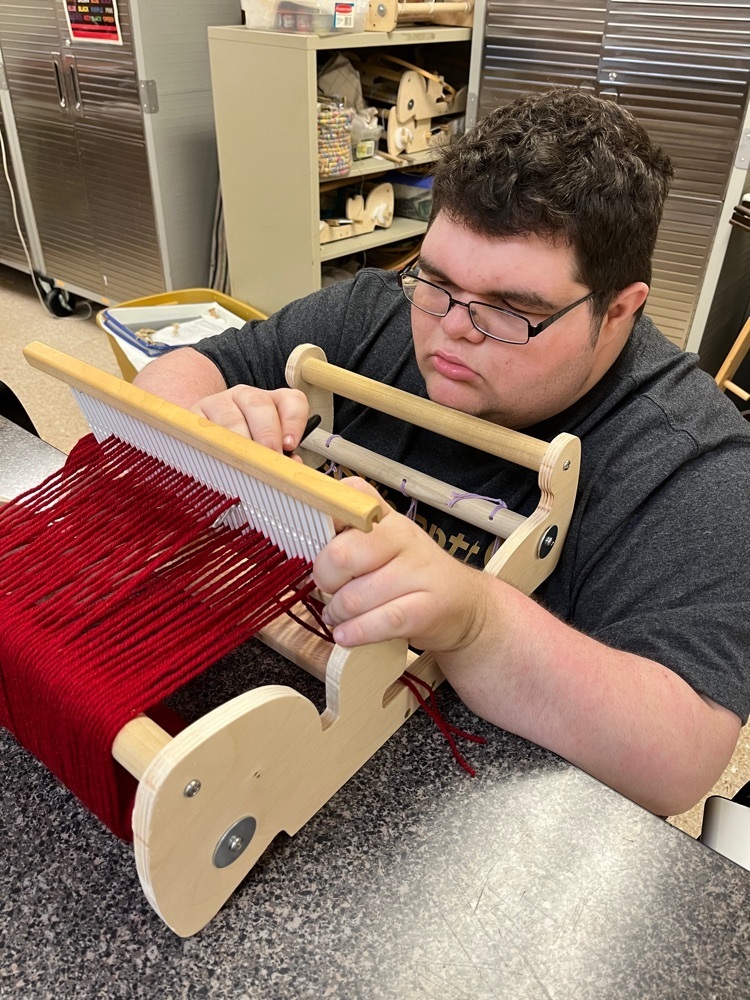 Levi Strahl setting up loom for his next weaving
