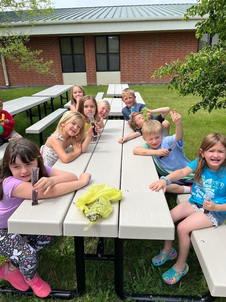 Kindergarten using outdoor tables 