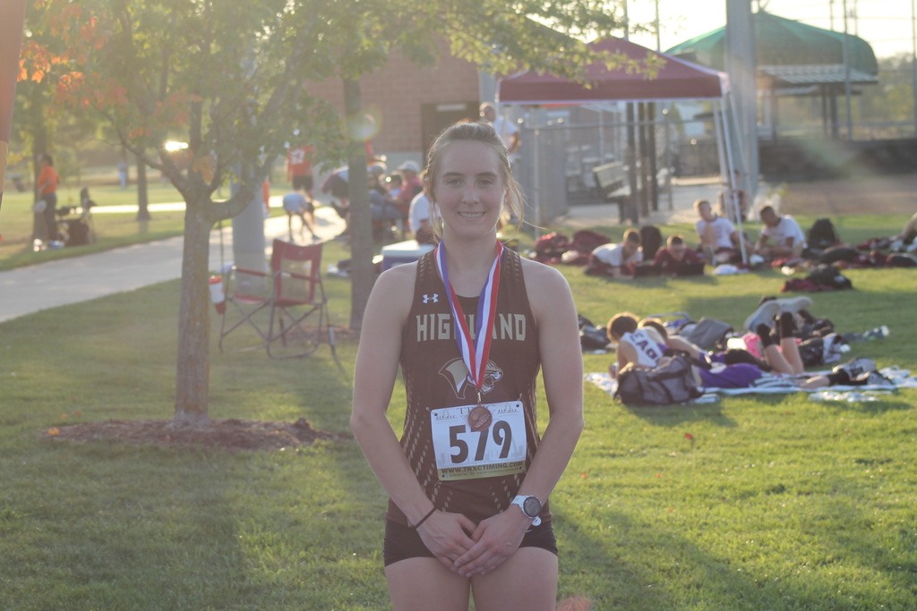 Senior Kaycie Stahl wearing her medal from the Moberly Invitational Cross Country Meet