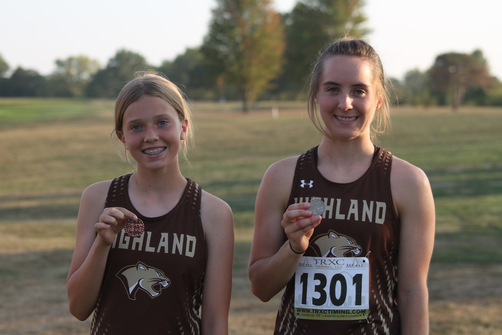 Pictured from left to right: AJ Caudill holding her Conference Medal and Kaycie Stahl holding her 2nd team, All-Conference medal.